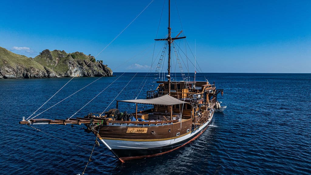 Amaya Explorer liveaboard anchored near tropical island
